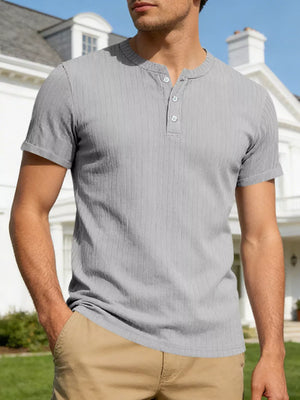 Men's gray ribbed short-sleeve henley with button placket and rolled cuffs.