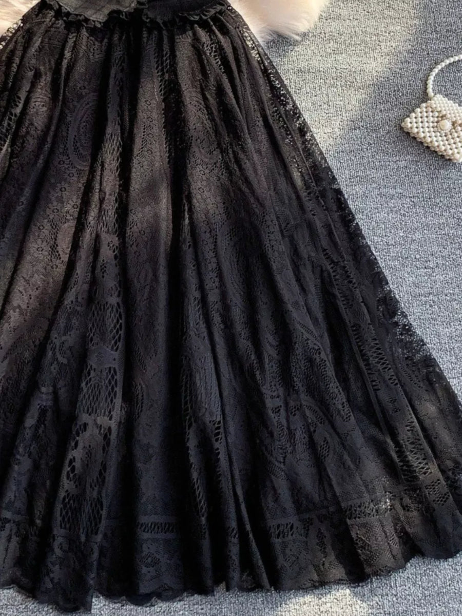 Black lace dress with puff sleeves and intricate lace detailing.