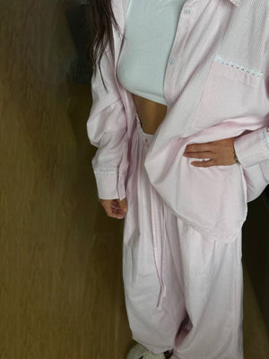Pinstriped dusty pink long sleeve pajama set with lace trim on pockets and cuffs.
