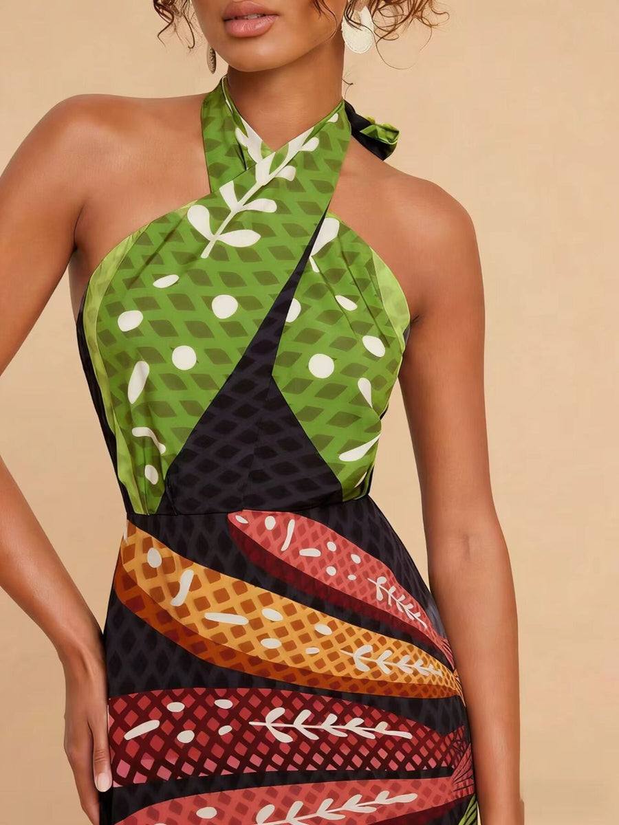 Tropical print halter neck midi dress with green, black, and colorful leaf patterns.