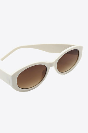 Beige sculpted oval frame sunglasses with brown lenses