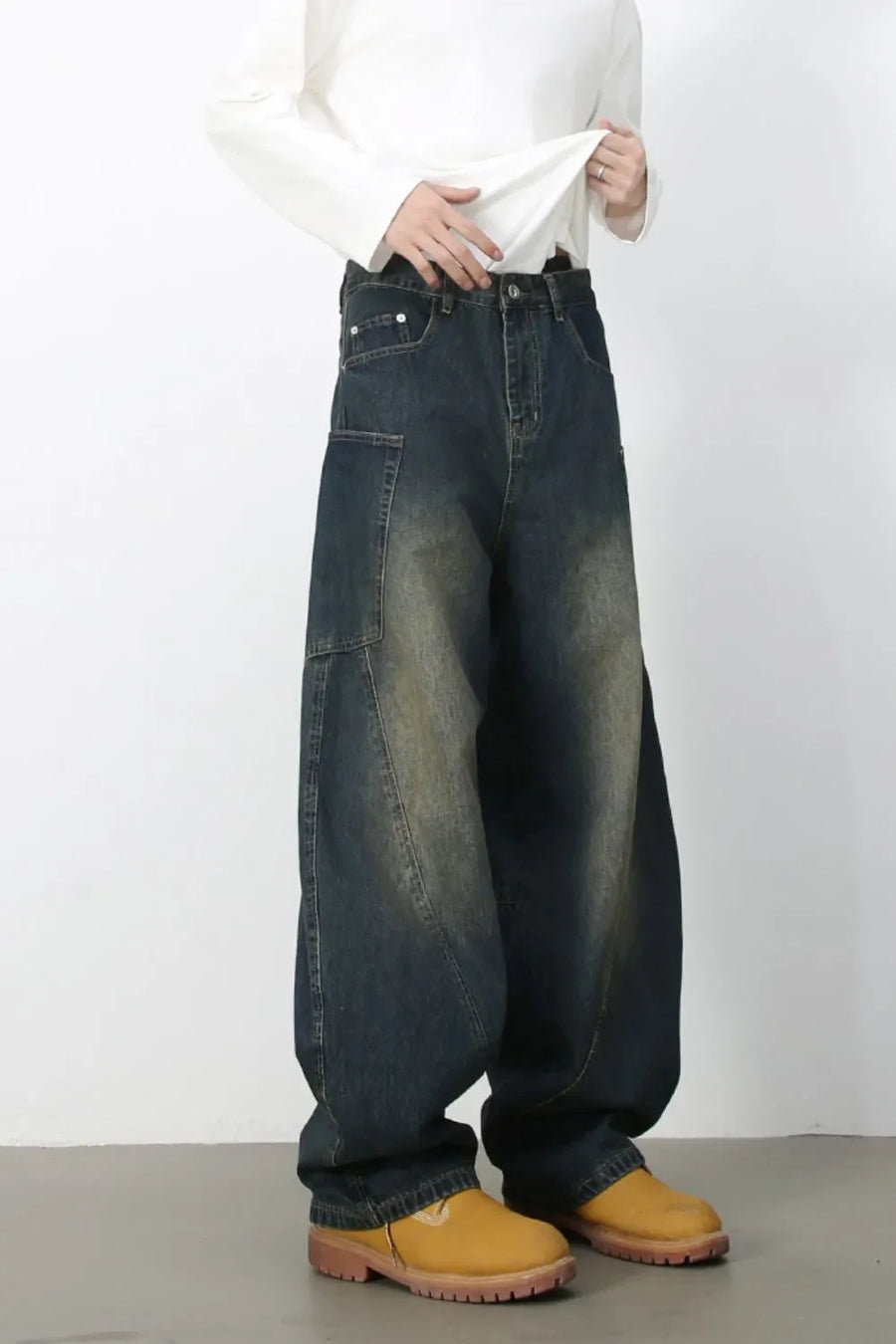 Sculpted denim balloon trousers in dark wash with unique paneling and a relaxed fit.