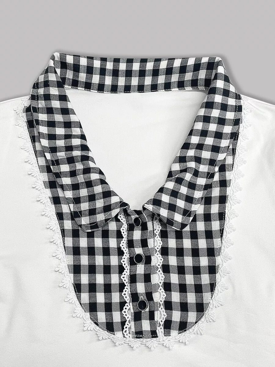 White maternity shirt with black gingham collar, lace trim, and decorative buttons.