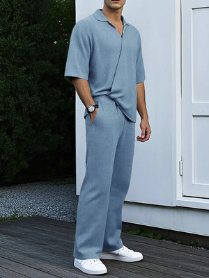 Men's blue ribbed knit polo shirt and wide-leg pants set with a notched collar and short sleeves.