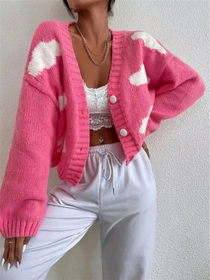 Hot pink acrylic button cardigan with white cloud pattern, V-neck, and long sleeves.