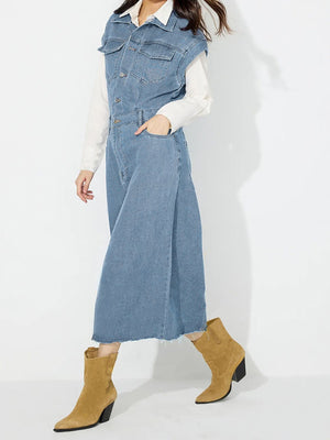 Sleeveless denim midi dress in light wash with button front, pockets, and slit.