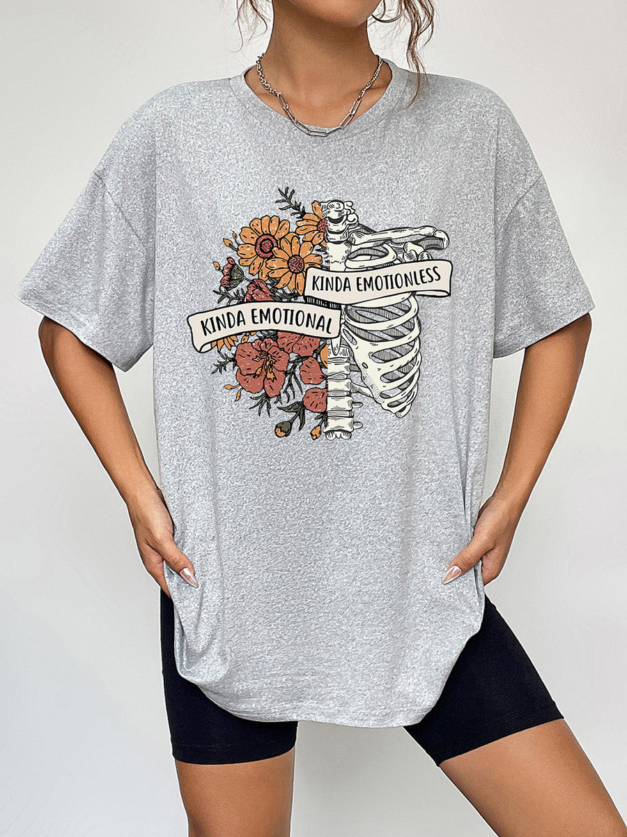 Grey polyester t-shirt with a skeleton and floral graphic that says "Kinda Emotional" and "Kinda Emotionless".