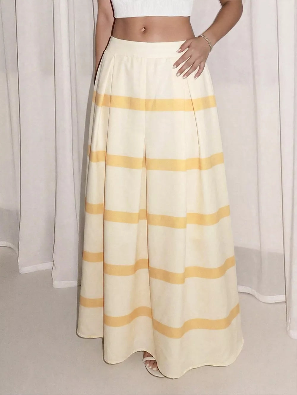 Flowy maxi skirt with yellow horizontal stripes and pockets, a comfortable casual style.