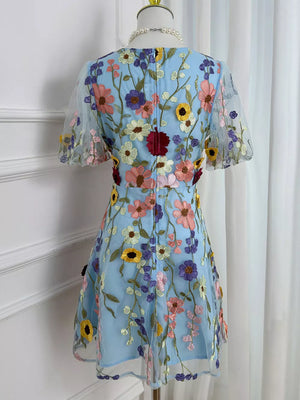 Blue floral embroidered mesh dress with short puff sleeves and a flared skirt.