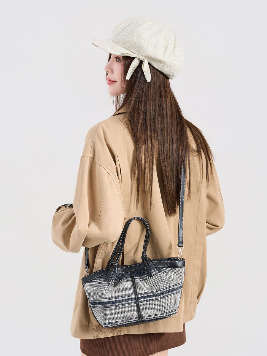 navy blue crossbody bag featuring leather trim and striped