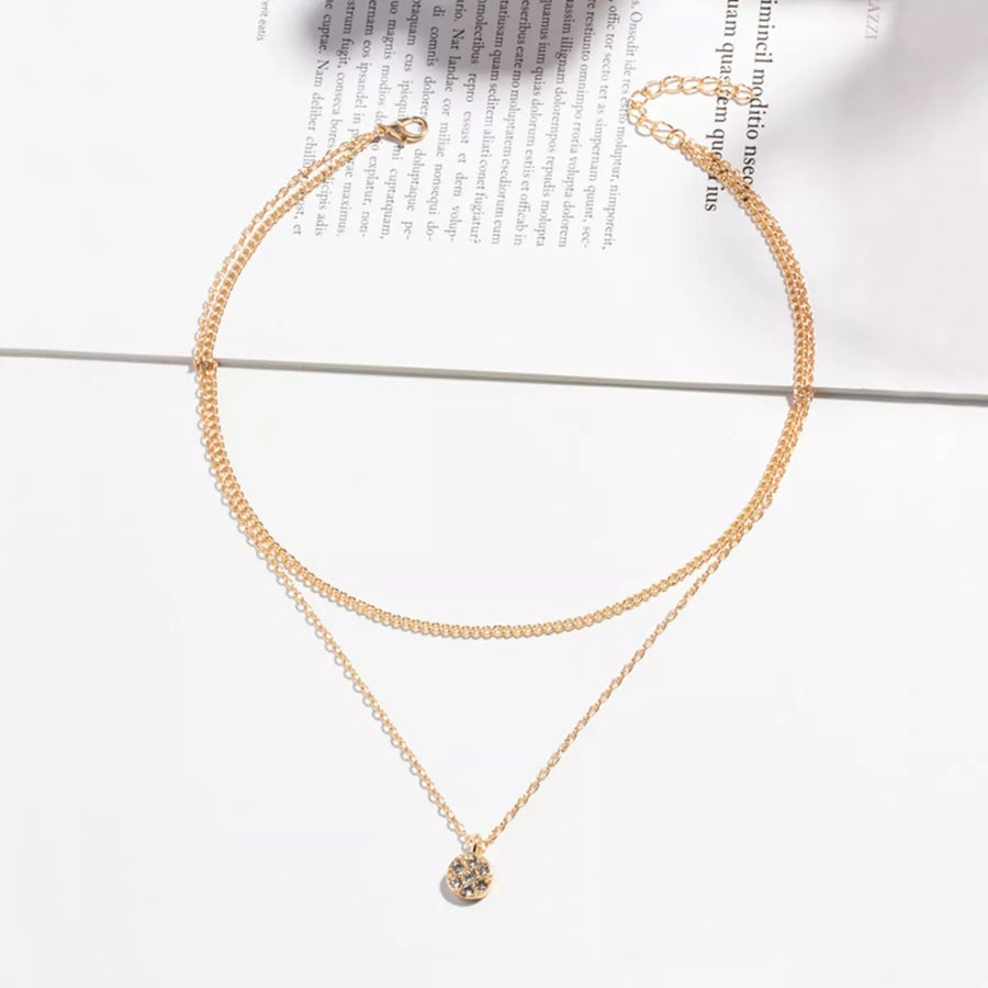 Gold double layered pendant necklace with textured disc charm