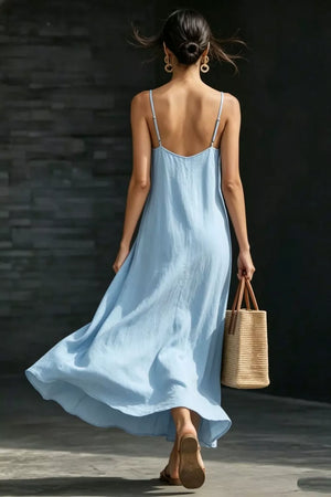 Light blue V-neck maxi dress with spaghetti straps and a breezy flowy skirt.