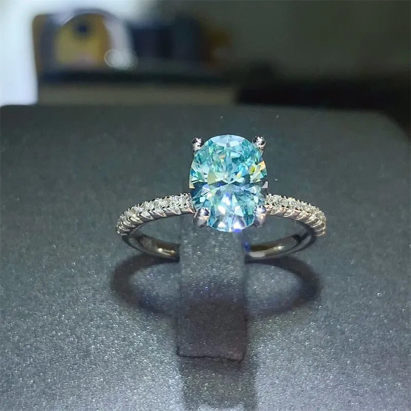 Silver ring with oval aqua moissanite and pavé band