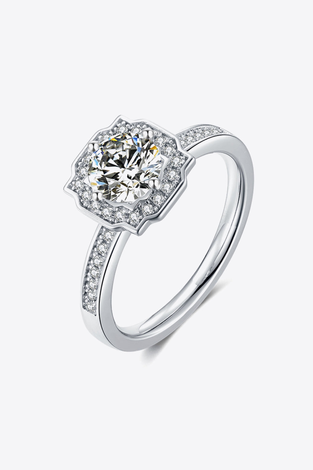 Silver halo engagement ring with round center diamond and pavé band.