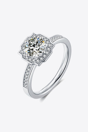 Silver halo engagement ring with round center diamond and pavé band.