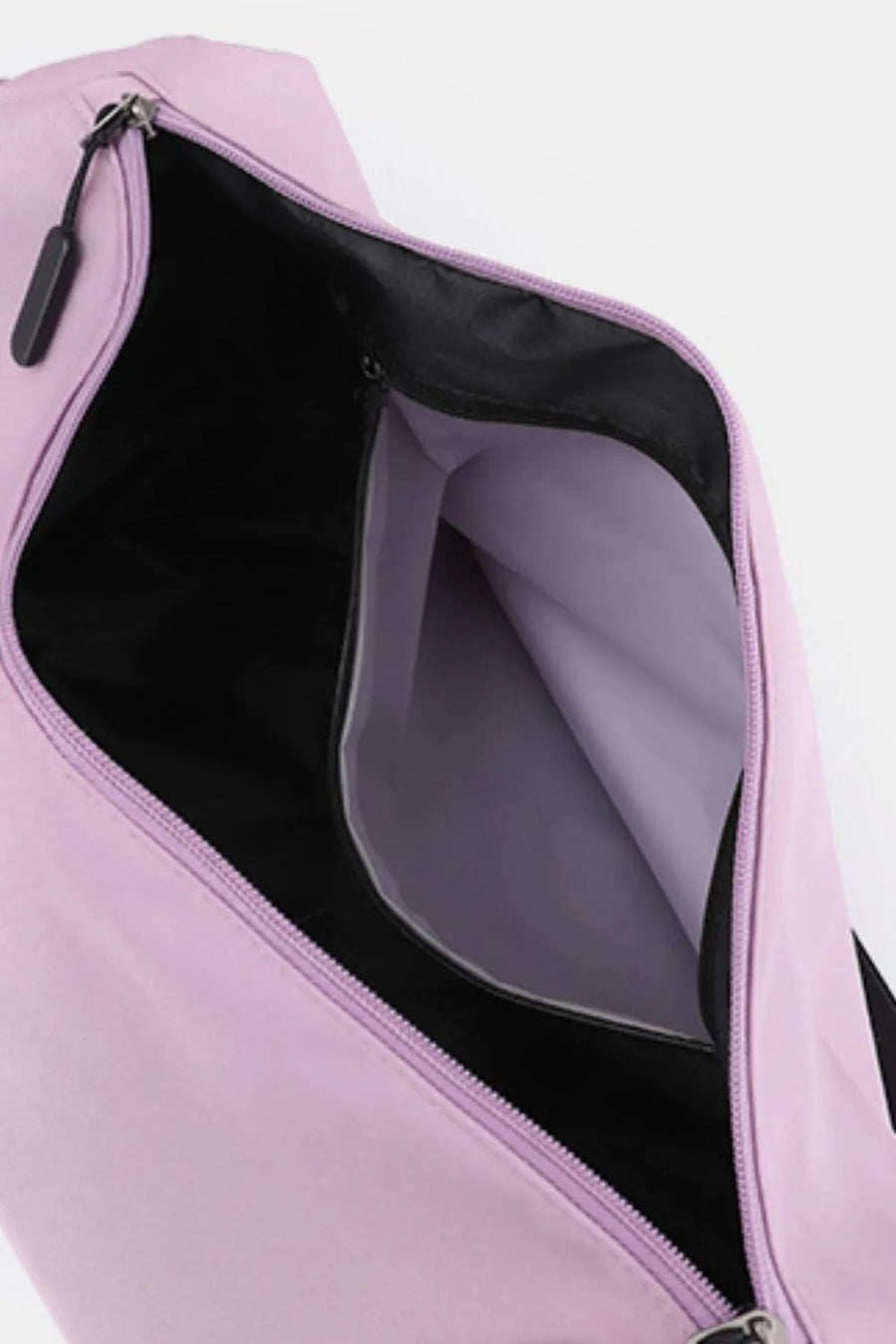 Slouchy crescent crossbody bag in Moonlit Mauve with open main compartment and interior pocket.