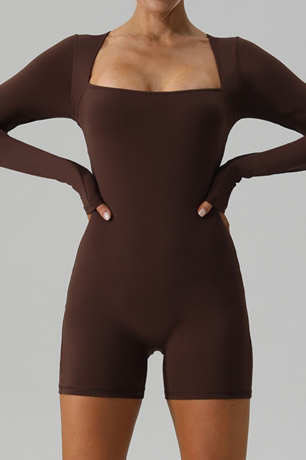 Brown long sleeve unitard with square neckline and thumbholes, short leg.