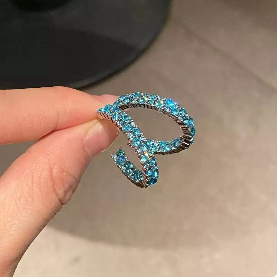 Sparkling pastel blue hoop earrings with pave-set stones on an alloy band.