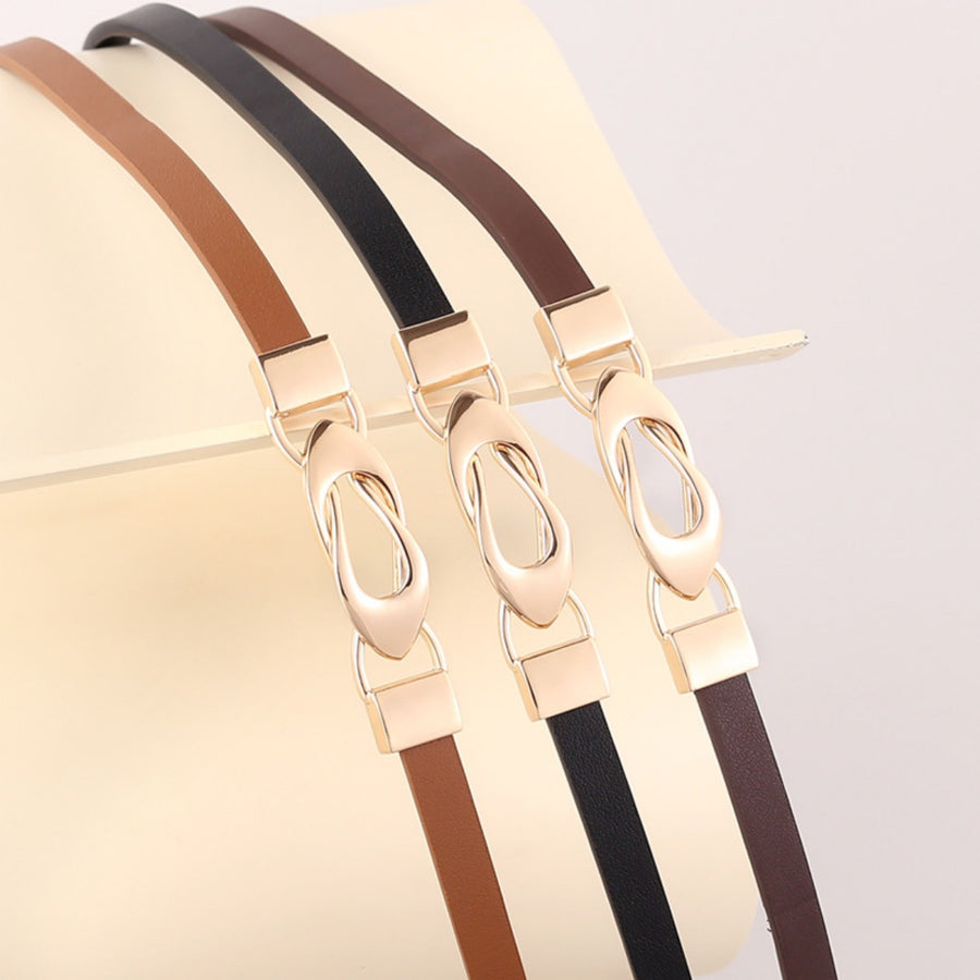 Elegant leather belts in brown, black, and caramel with interlocking gold buckles.