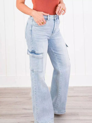 Light wash cotton wide-leg cargo jeans with flap pockets and a relaxed fit.