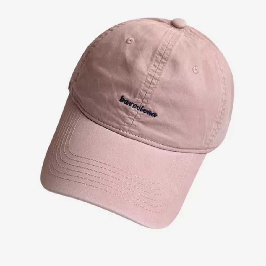 Pink baseball cap with embroidered "Barcelona" text and curved brim