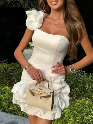 White ruffled one-shoulder mini dress with a fitted bodice and textured skirt.