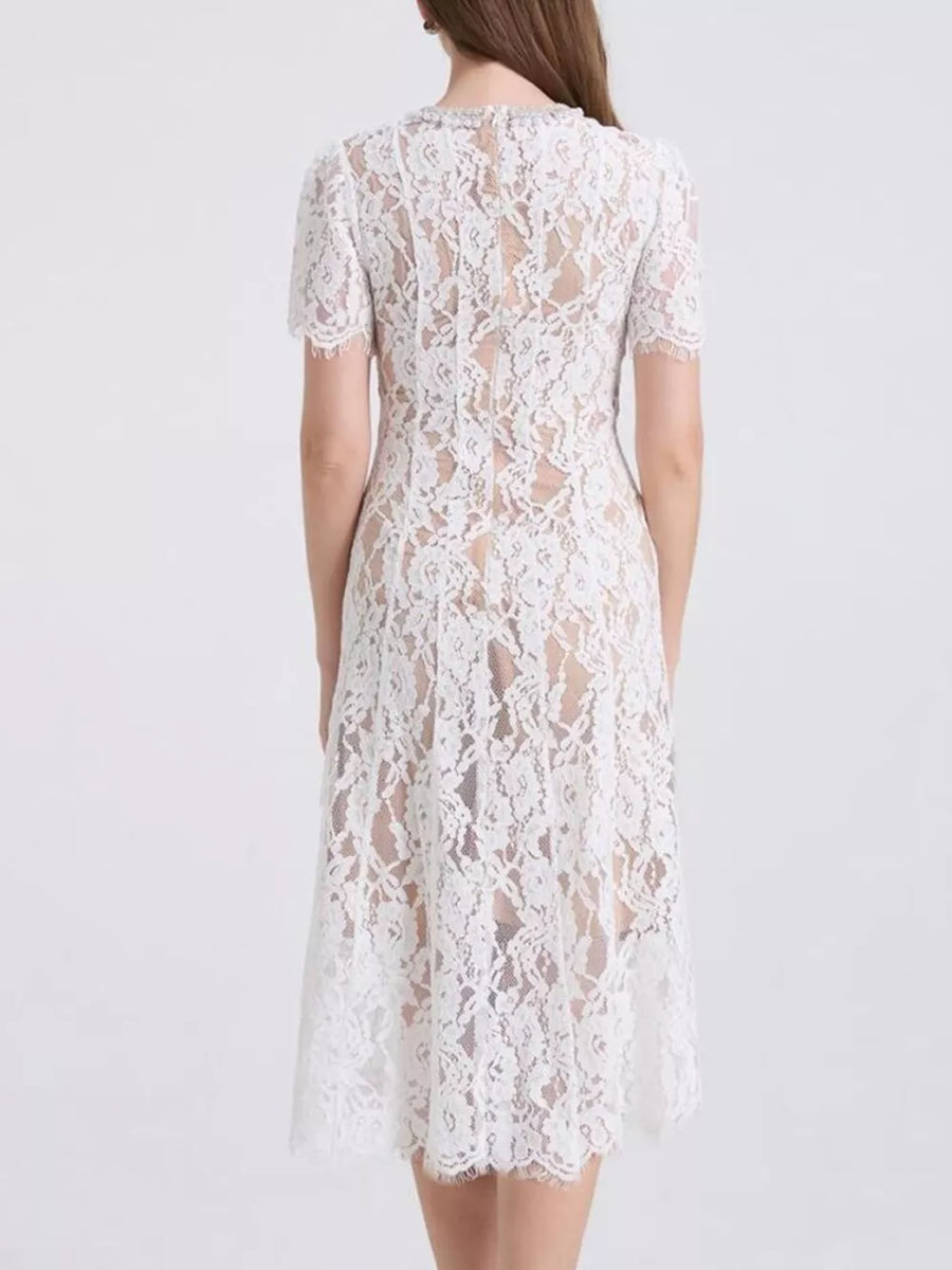 White lace midi dress with short sleeves and pearl embellishments at the neckline.