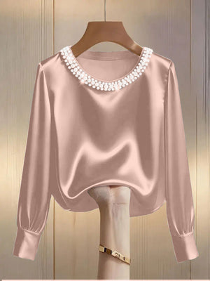 Pink satin blouse with pearl trim round neck and long sleeves
