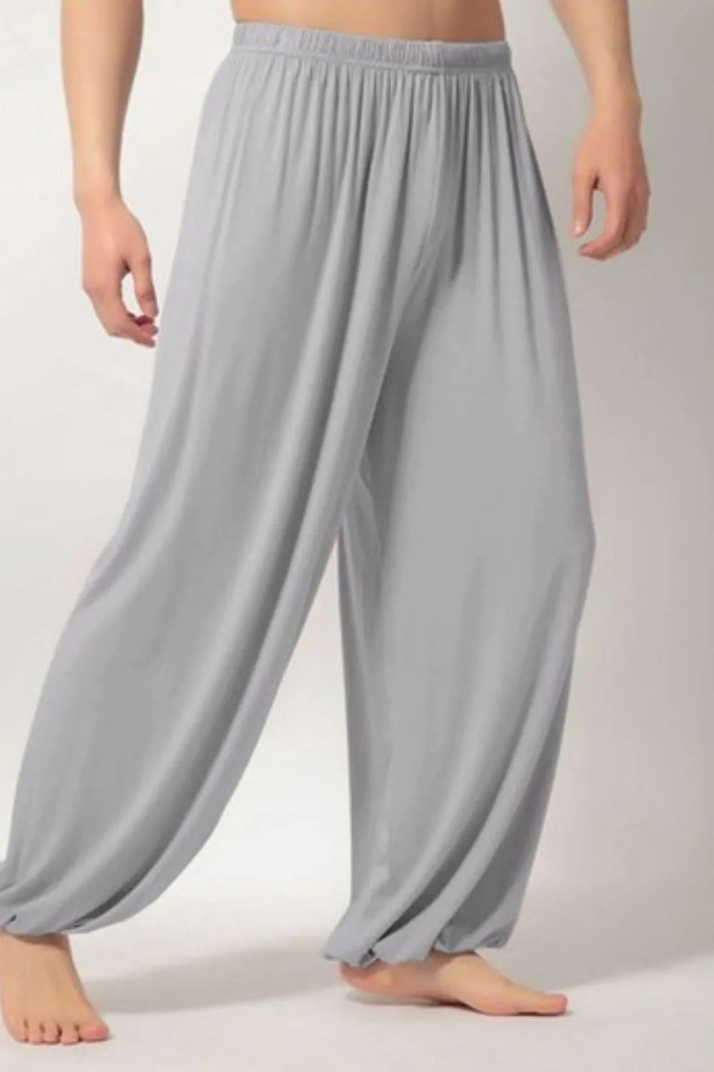 Gray relaxed drape harem pants with elastic waist and cinched ankles.