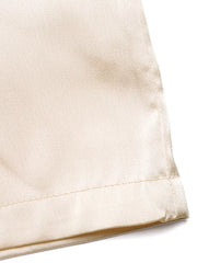 Champagne satin pants with a clean hem detail.