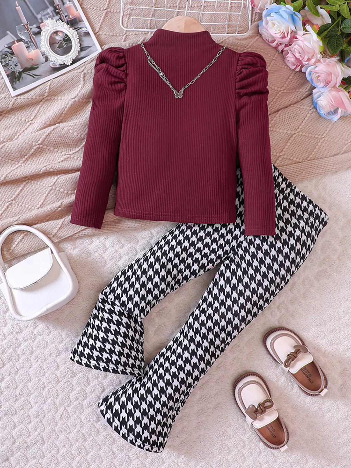 Wine red ribbed puff sleeve top with houndstooth flare pants and butterfly necklace.