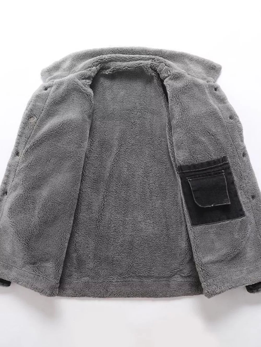 Gray sherpa-lined denim jacket interior with black chest pocket detail