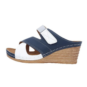 Navy and white colorblock crossover wedge sandals with adjustable strap.