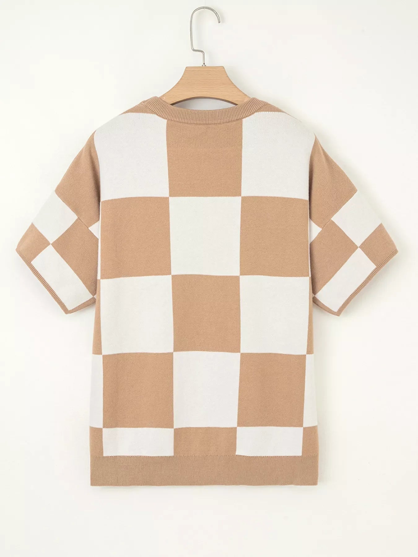 Drop shoulder sweater in camel and white checkerboard pattern with short sleeves.