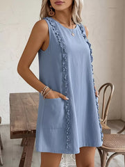 Light blue sleeveless dress with frill trim and pockets.