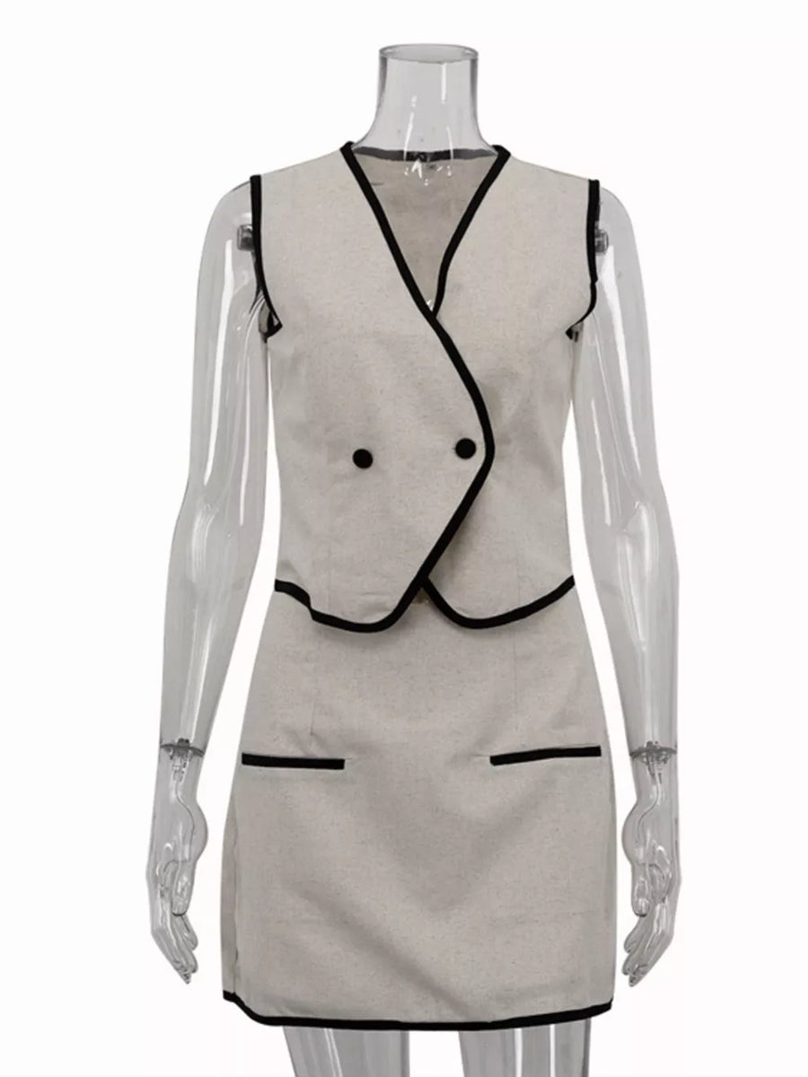 Sleeveless beige mini dress with black trim and double-breasted vest detail