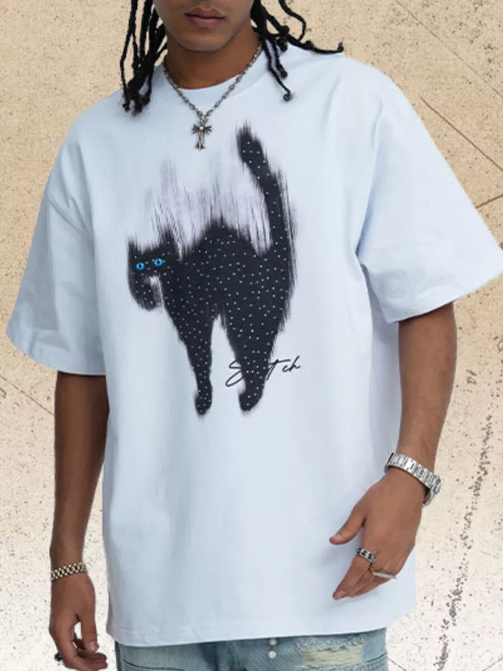 White cotton t-shirt with a black cat graphic and rhinestone accents.