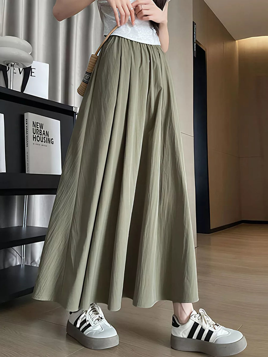 Olive green maxi skirt with pockets, featuring a flowy A-line cut and subtle texture.