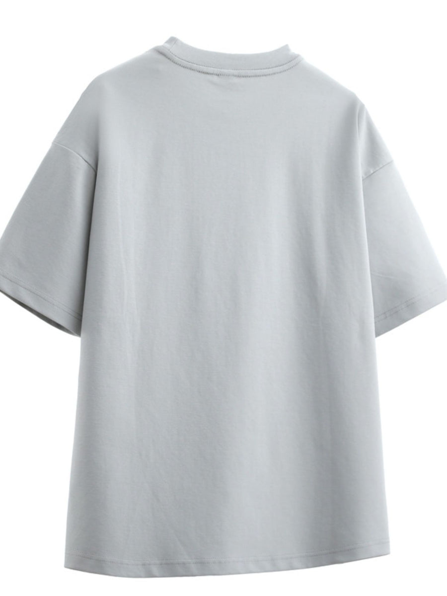 Men's oversized dusty gray cotton graphic t-shirt with crew neck and short sleeves.