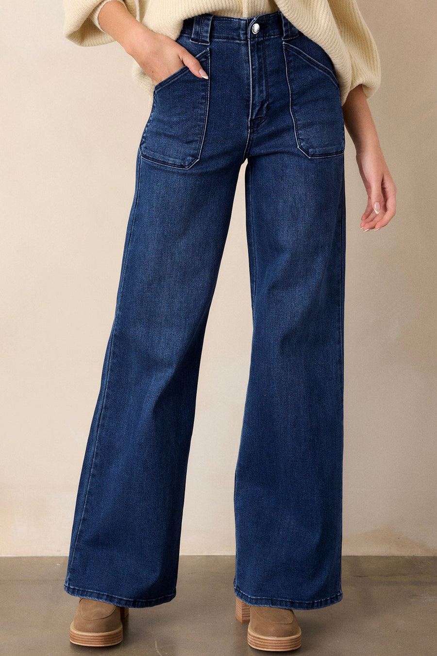 Mid-rise straight leg jeans in dark wash denim with utility pockets and button closure.