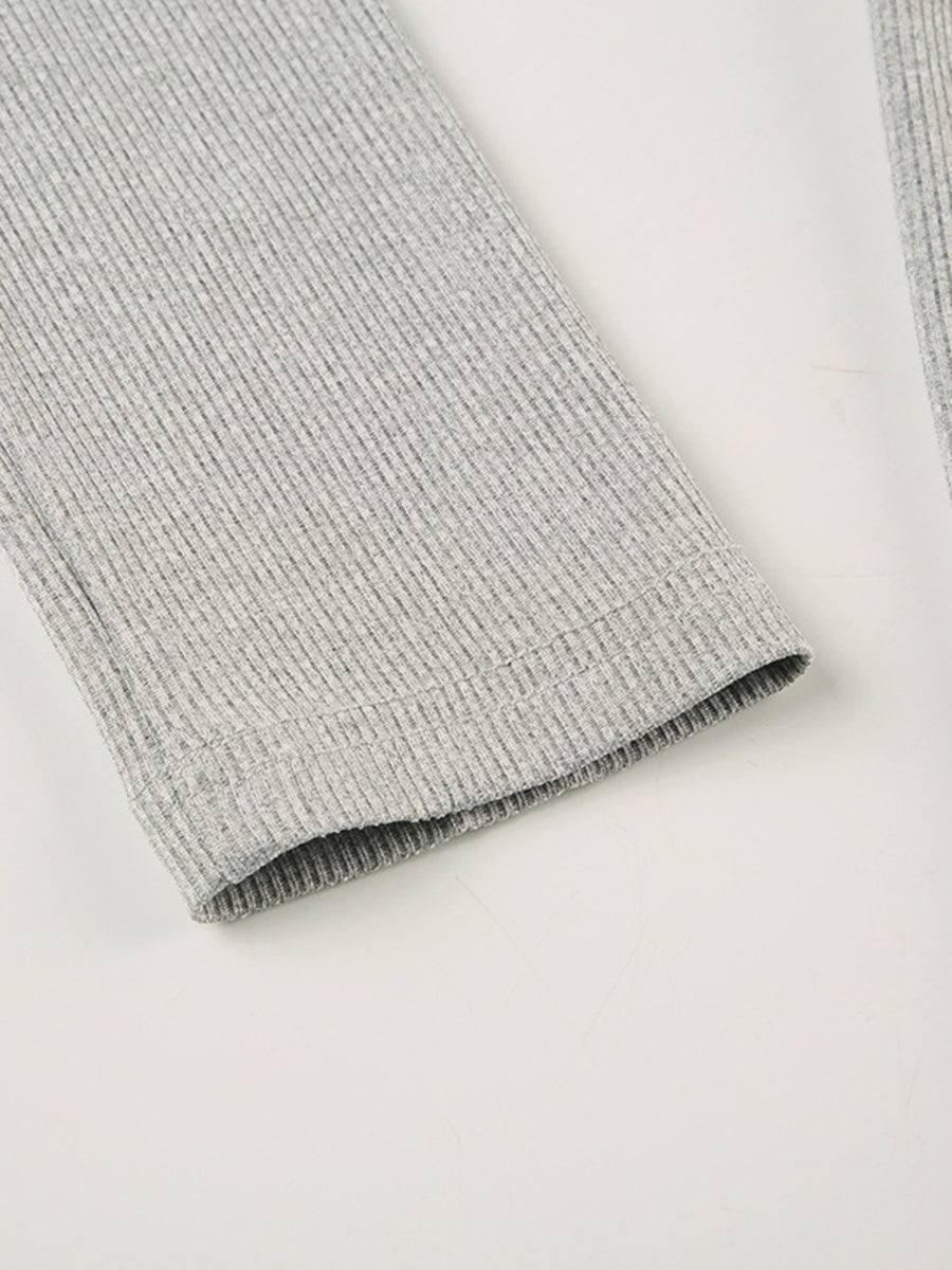 Gray ribbed long sleeve romper detail showing textured fabric and hem