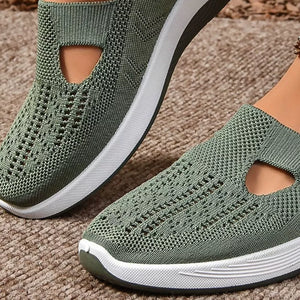 Green breathable mesh slip-on shoes with cut-out detail and white chunky sole.