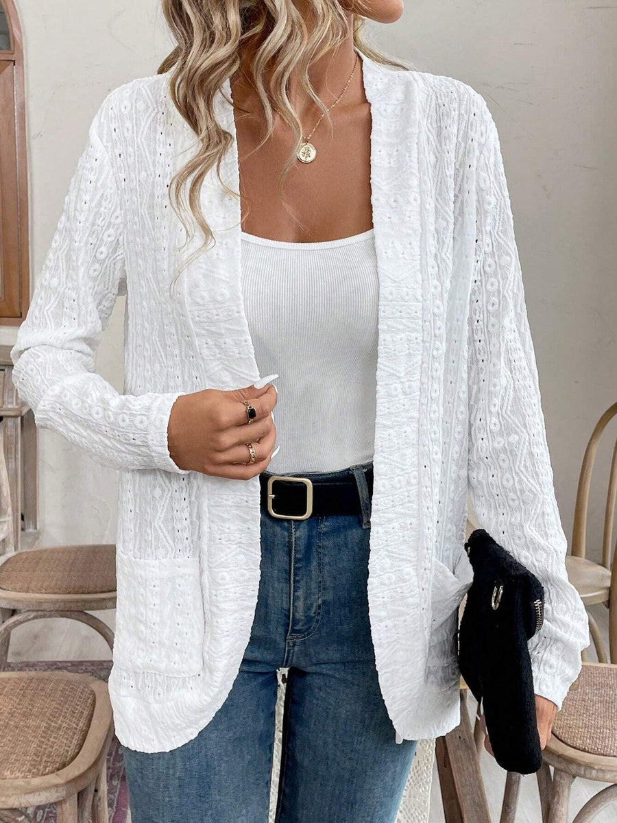 White open-weave embroidered cardigan with pockets, open front, and long sleeves.
