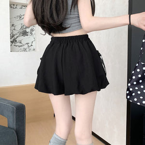 Black high waist bubble skirt with bowknot details and elastic waistband.