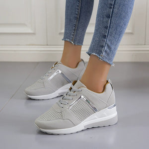 Grey lace-up wedge sneakers with metallic accents and perforated details.