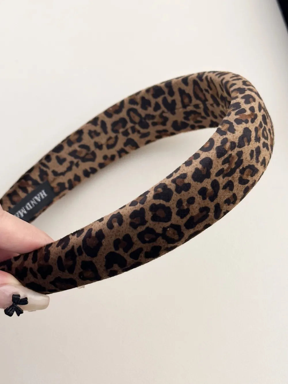 Leopard print padded headband in brown and tan with a comfortable, wide design.