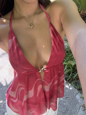 Backless halter neck cami top with abstract pink pattern and starfish closure.