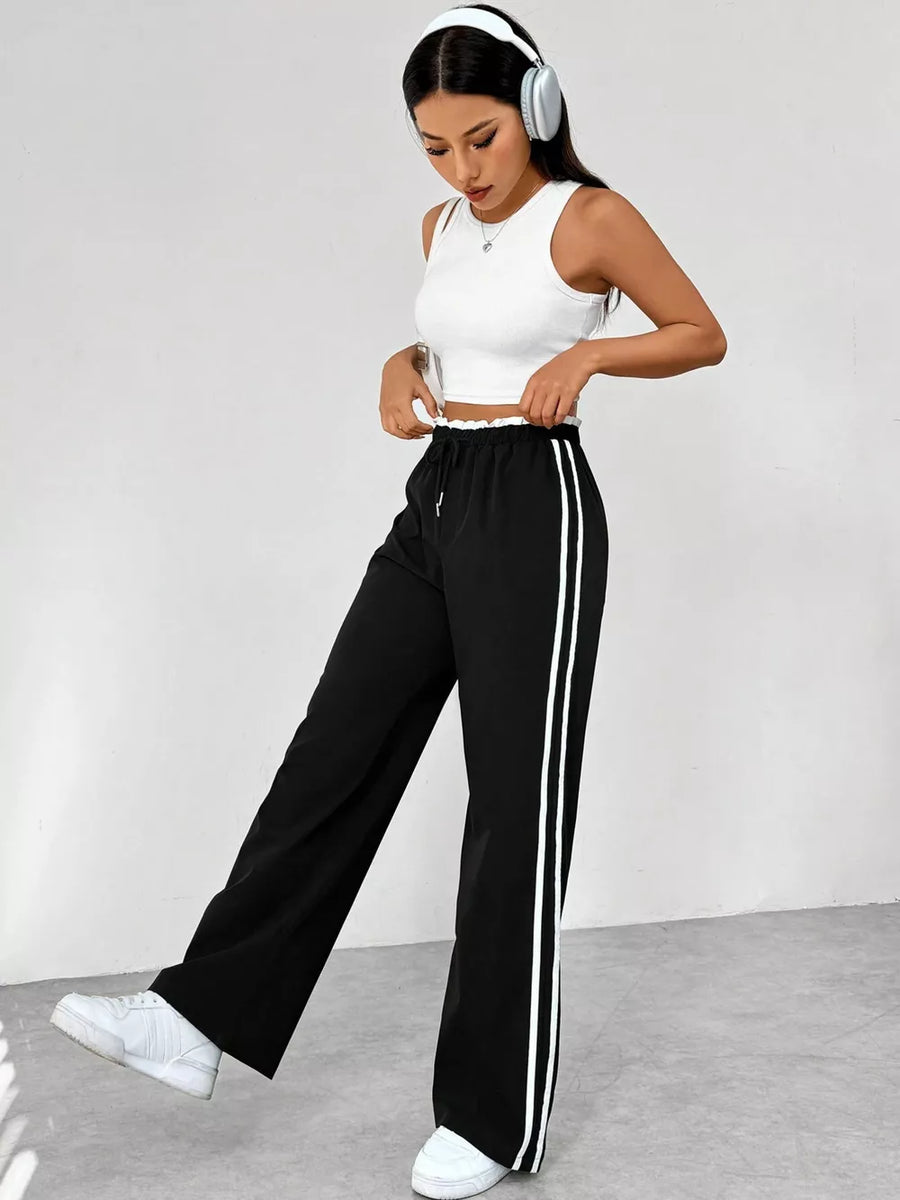 Chic black maternity pants with drawstring and white side stripes, wide leg
