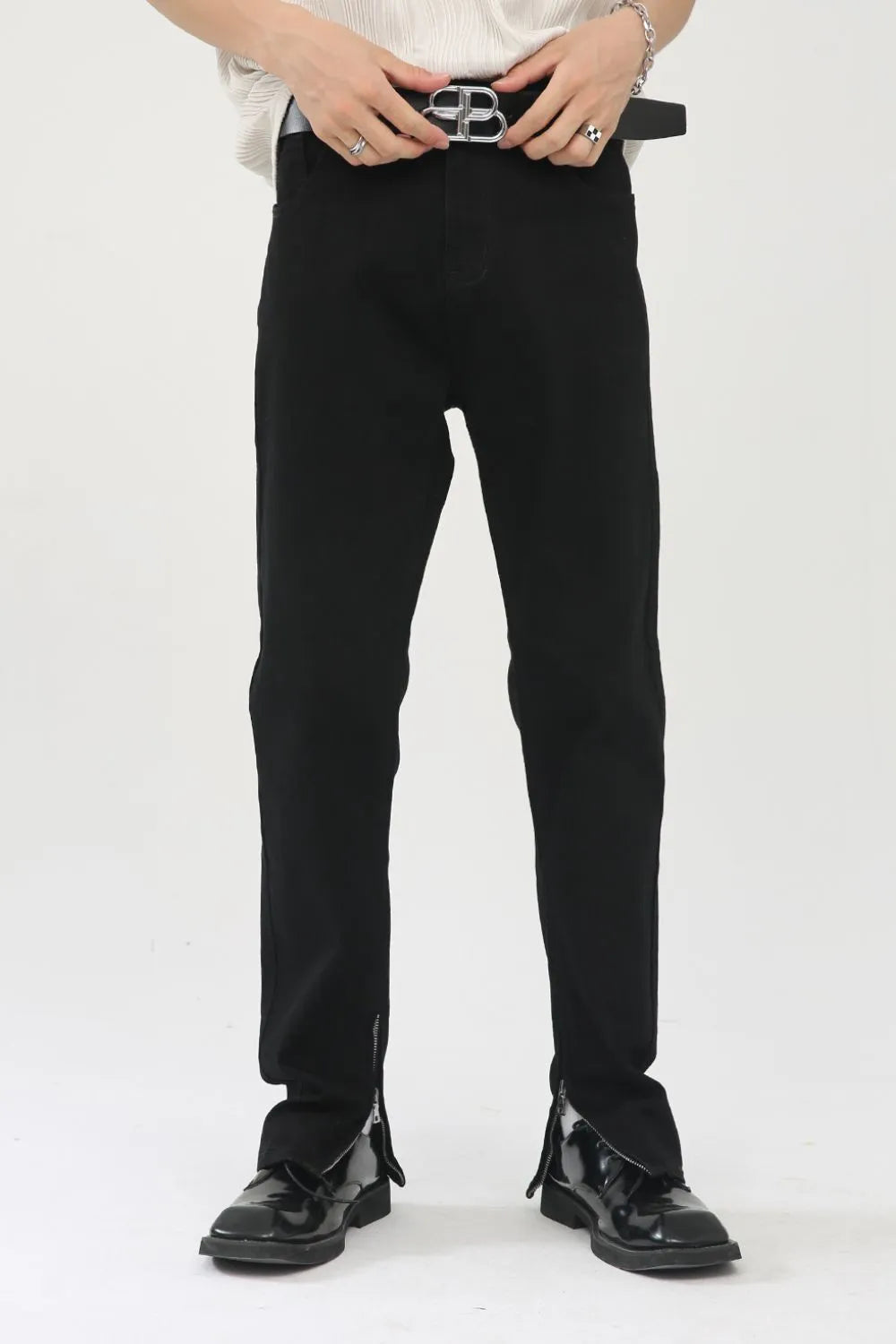 Black denim trousers with zip hem detail and a straight leg cut.