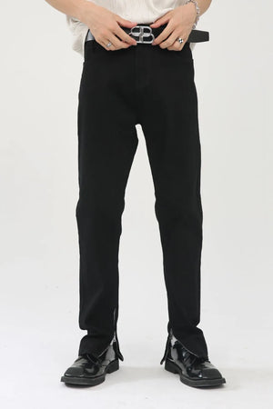 Black denim trousers with zip hem detail and a straight leg cut.